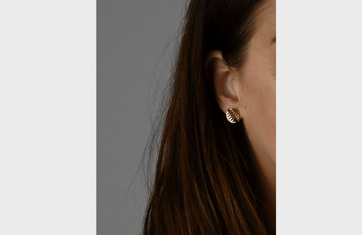 Woman Wearing Gold Wavy Earrings