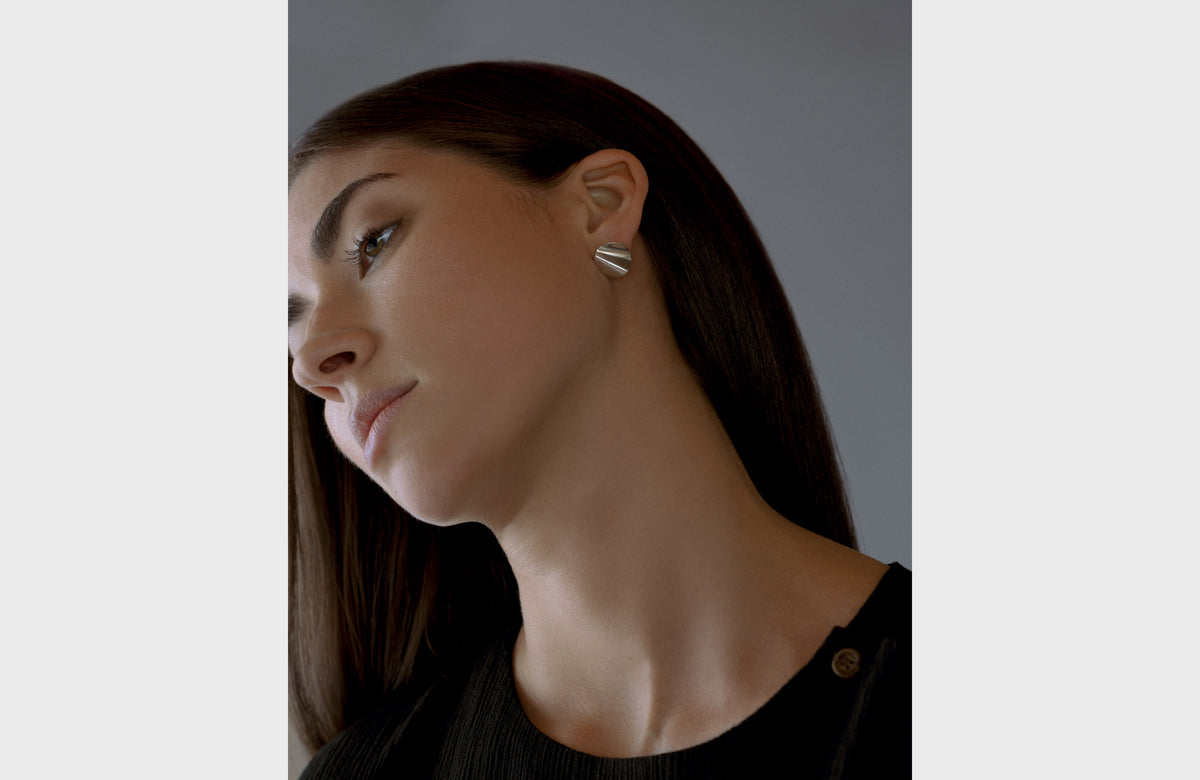 Woman Wearing Round Wavy Earrings