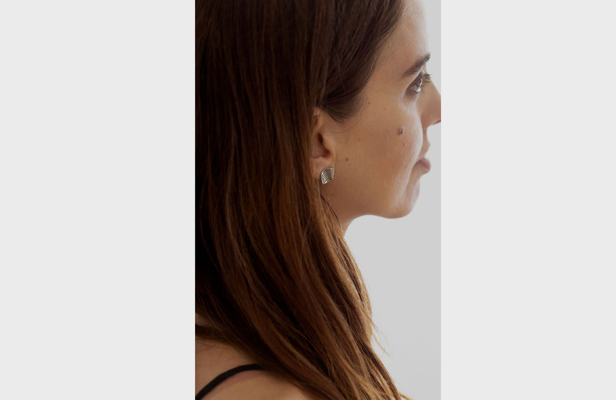 Woman Wearing Wavy Silver Studs